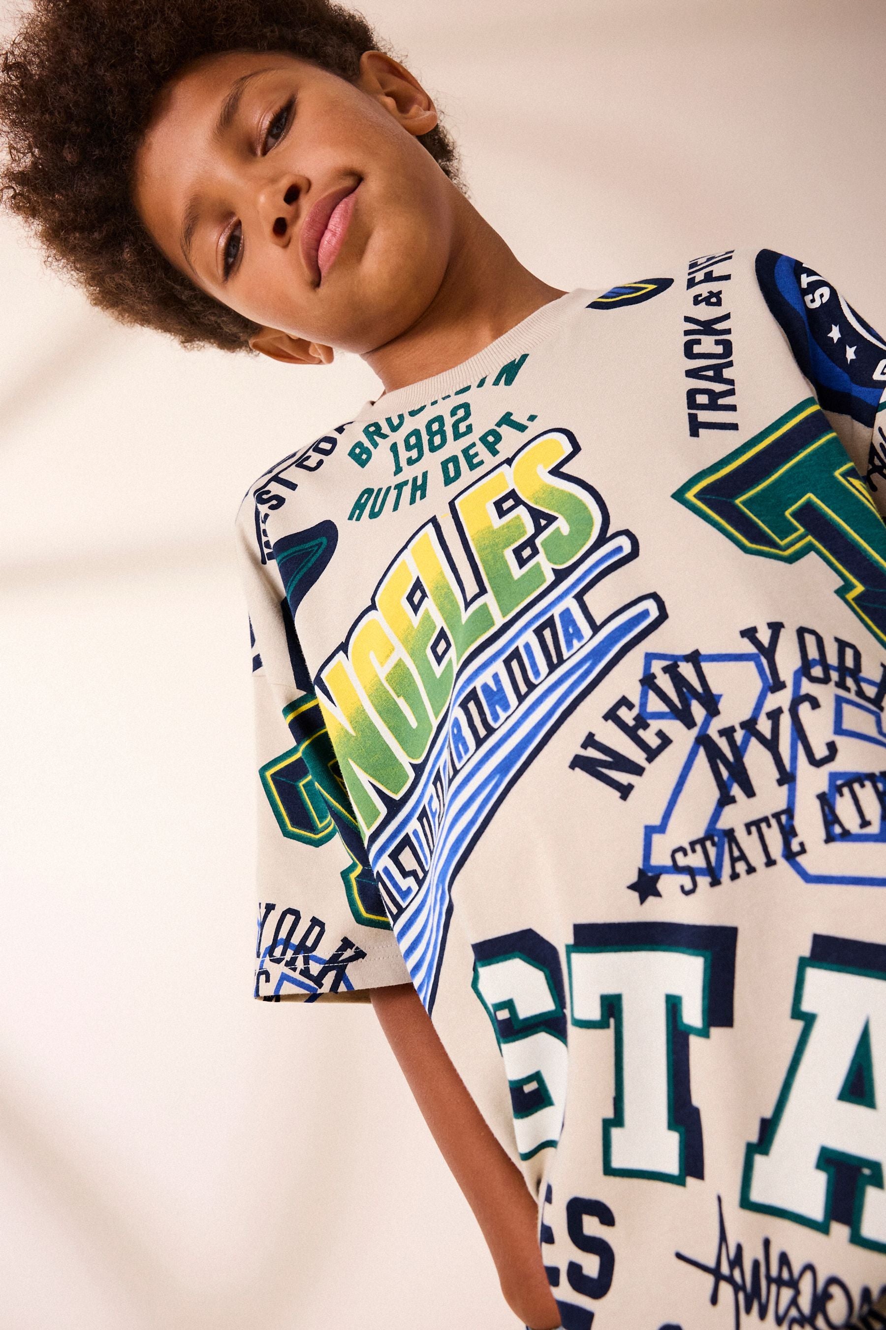 Stone All Over Print Short Sleeve Relaxed Fit Varsity T-Shirt (3-16yrs)